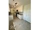 Well-lit kitchen with white cabinets, granite countertops, and stainless-steel appliances at 1945 Plantation Ln, Martinsville, IN 46151