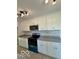 Kitchen with stainless steel appliances, granite counters, and white cabinets at 1945 Plantation Ln, Martinsville, IN 46151