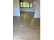 Bright living room features shiny hardwood floors and large window for natural light at 1945 Plantation Ln, Martinsville, IN 46151