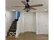 Cozy room with a staircase with carpeted steps and a ceiling fan, and doors at 1945 Plantation Ln, Martinsville, IN 46151