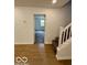 View of staircase with wooden floors, white walls and a door opening to a room at 1945 Plantation Ln, Martinsville, IN 46151