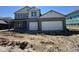 Two-story home boasts a two-car garage, gray brick facade and a covered porch entry, sitting on an unfinished lot at 201 Ames Dr, Whiteland, IN 46184