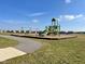 Community playground featuring swings, slide, and climbing structure for outdoor fun on a sunny day at 201 Ames Dr, Whiteland, IN 46184