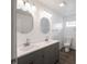 Bathroom featuring double sink vanity, oval mirror, and a tiled floor at 204 N Vine St, Shelbyville, IN 46176
