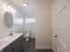Bathroom featuring double sink vanity, oval mirror, and a tiled floor at 204 N Vine St, Shelbyville, IN 46176