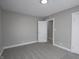 A gray toned bedroom features neutral carpet, a closet, and trim at 204 N Vine St, Shelbyville, IN 46176