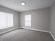 Bedroom with carpet, neutral walls, and two windows at 204 N Vine St, Shelbyville, IN 46176