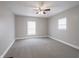 Empty bedroom featuring plush carpet, two windows with blinds, and neutral-toned walls at 204 N Vine St, Shelbyville, IN 46176