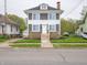 Charming two-story home featuring a stone facade, gray siding, and a well-manicured front lawn at 204 N Vine St, Shelbyville, IN 46176