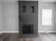 Living room features a painted brick fireplace with decorative mantle and view of the window at 204 N Vine St, Shelbyville, IN 46176