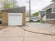 View of the garage, driveway, and backyard from the rear of the property at 204 N Vine St, Shelbyville, IN 46176