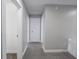 Hallway with neutral carpet flooring that opens to several rooms and a staircase at 204 N Vine St, Shelbyville, IN 46176