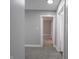 Hallway with neutral walls, carpeted floor, and white trim doors leading to other rooms at 204 N Vine St, Shelbyville, IN 46176