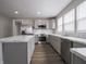 Bright kitchen with stainless appliances, island, marble countertops, and stylish gray cabinets at 204 N Vine St, Shelbyville, IN 46176