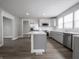 Modern kitchen with stainless appliances, marble countertops, grey cabinets, and subway tile backsplash at 204 N Vine St, Shelbyville, IN 46176