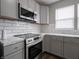 Bright kitchen featuring stainless oven and microwave, gray cabinets and stunning countertops at 204 N Vine St, Shelbyville, IN 46176