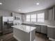 Modern kitchen featuring stainless appliances, marble countertops, grey cabinets and island at 204 N Vine St, Shelbyville, IN 46176