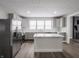 Spacious kitchen with stainless steel refrigerator, ample counter space, and a stylish kitchen island at 204 N Vine St, Shelbyville, IN 46176