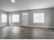 Bright living room featuring freshly painted walls, new floors, and natural light from large windows at 204 N Vine St, Shelbyville, IN 46176