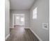 Bright living room with hardwood flooring and a white front door at 204 N Vine St, Shelbyville, IN 46176
