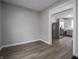 Open living room featuring hardwood floors, neutral paint, and an open doorway to the kitchen at 204 N Vine St, Shelbyville, IN 46176