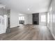 Open living room with a fireplace and wood floors, showcasing a seamless transition to the kitchen at 204 N Vine St, Shelbyville, IN 46176
