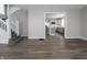 Open-concept living area with sleek stairs and light gray walls, flowing into a modern kitchen at 204 N Vine St, Shelbyville, IN 46176