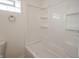 Bathroom shower featuring white surround, a towel rack, and a window at 204 N Vine St, Shelbyville, IN 46176