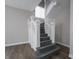 Traditional staircase with decorative wood banisters and hardwood floors at 204 N Vine St, Shelbyville, IN 46176