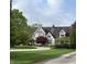 Charming home featuring classic architectural details, a circular driveway, and lush landscaping at 2090 Mulsanne Dr, Zionsville, IN 46077
