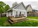 Backyard featuring a detached garage, wooden deck with picnic table, and a well-maintained green lawn at 2237 N New Jersey St, Indianapolis, IN 46205