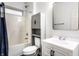 Bathroom featuring a shower-tub combo, modern cabinet, and large mirror at 2237 N New Jersey St, Indianapolis, IN 46205