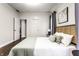 Cozy bedroom featuring a large bed, neutral colors, and an adjacent doorway at 2237 N New Jersey St, Indianapolis, IN 46205