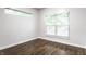 Empty room featuring a bright window and rich hardwood flooring at 2237 N New Jersey St, Indianapolis, IN 46205