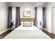 Bright bedroom with a large bed, stylish headboard, and matching side tables with modern lamps at 2237 N New Jersey St, Indianapolis, IN 46205