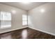 Empty room featuring two bright windows and rich hardwood flooring at 2237 N New Jersey St, Indianapolis, IN 46205