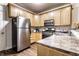 Modern kitchen features stainless steel refrigerator, oven, and wooden cabinetry at 2237 N New Jersey St, Indianapolis, IN 46205