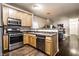 Spacious kitchen with stainless steel appliances, light wood cabinets, and open view to living area at 2237 N New Jersey St, Indianapolis, IN 46205