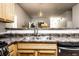 Modern kitchen sink with stainless steel appliances and fixtures, showcasing bright, open living space at 2237 N New Jersey St, Indianapolis, IN 46205