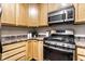 Close-up of a kitchen featuring wooden cabinetry, stainless steel oven, and modern countertops at 2237 N New Jersey St, Indianapolis, IN 46205