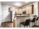 Well-equipped kitchen with stainless steel appliances, breakfast bar, and ample cabinet space at 2237 N New Jersey St, Indianapolis, IN 46205