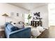 Cozy open-concept living space with plush blue sofa, checkerboard rug, and stylish decor create an inviting ambiance at 2237 N New Jersey St, Indianapolis, IN 46205