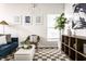 Bright open concept living area with a soft chair, modern decor, and natural light creates a cozy atmosphere at 2237 N New Jersey St, Indianapolis, IN 46205