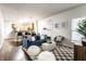 Inviting living room with open floor plan features a blue couch, modern decor, and seamless flow to the kitchen at 2237 N New Jersey St, Indianapolis, IN 46205