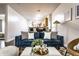 Cozy living room showcasing a comfortable blue sofa, stylish decor, and seamless flow to the kitchen at 2237 N New Jersey St, Indianapolis, IN 46205