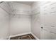 Empty walk-in closet featuring wire shelving, wood-look flooring, and a convenient door at 2237 N New Jersey St, Indianapolis, IN 46205