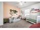 Bright Bedroom with playful decor, a crib, and comfortable seating at 2251 N New Jersey St, Indianapolis, IN 46205