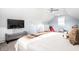 Bright, spacious bedroom featuring a gray bench, TV, and a glimpse of a playful ' area at 2251 N New Jersey St, Indianapolis, IN 46205