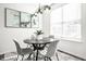 Modern dining area with a round table, stylish chairs, and elegant lighting fixture at 2251 N New Jersey St, Indianapolis, IN 46205