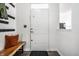 Bright entryway featuring a wooden bench, coat hooks, and a clean, modern design at 2251 N New Jersey St, Indianapolis, IN 46205